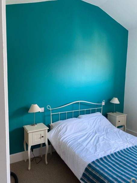 High ceiling and feature wall bedroom